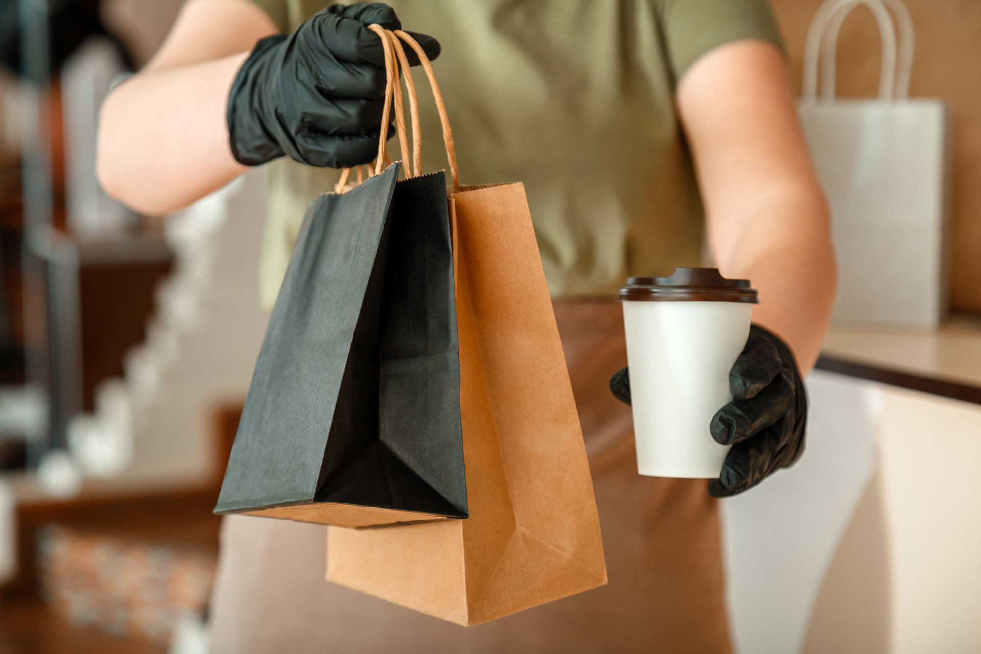 A cashier hands out a coffee order