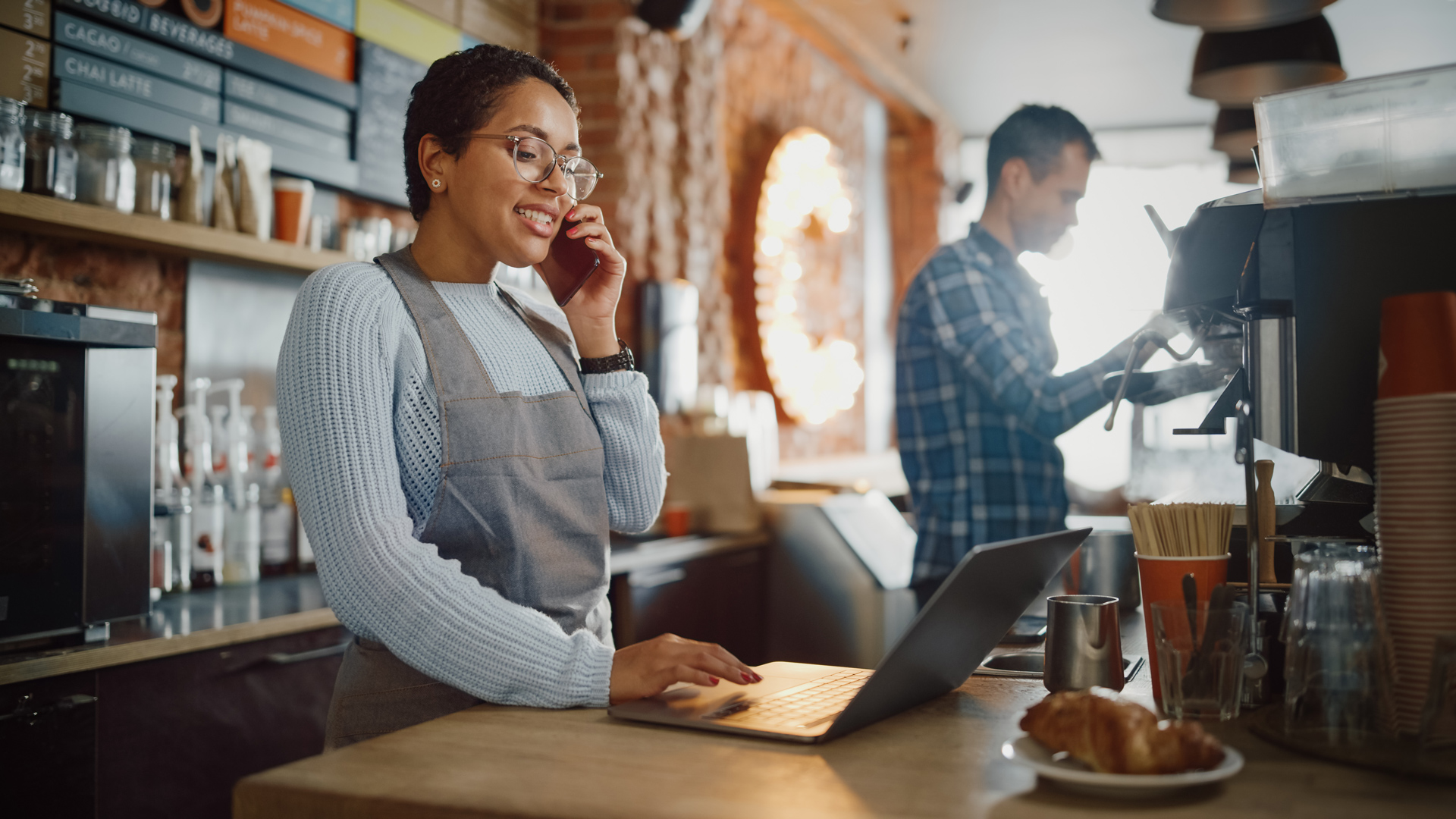 A cashier takes a customer call