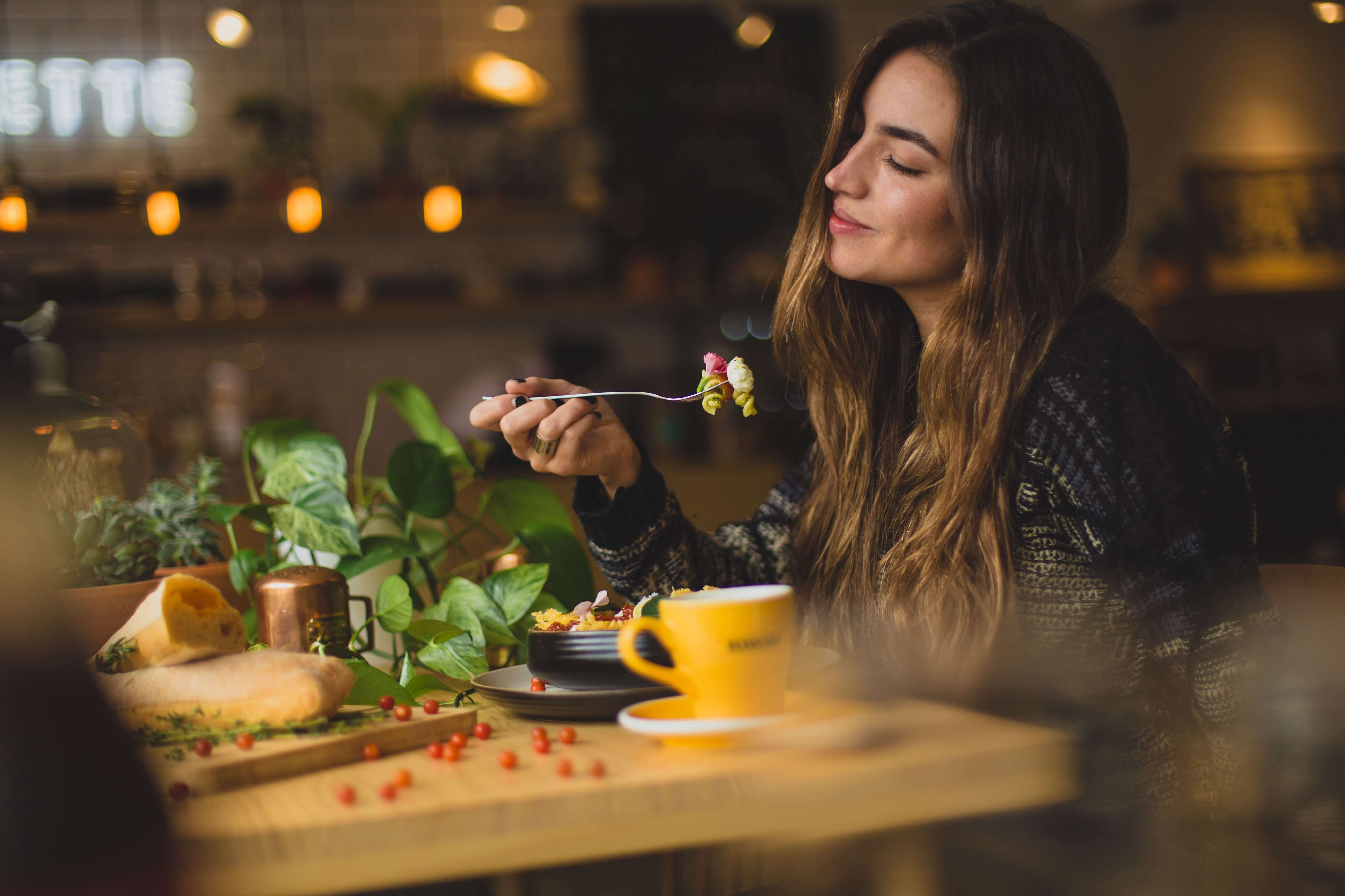 A woman savors a meal at a restaurant