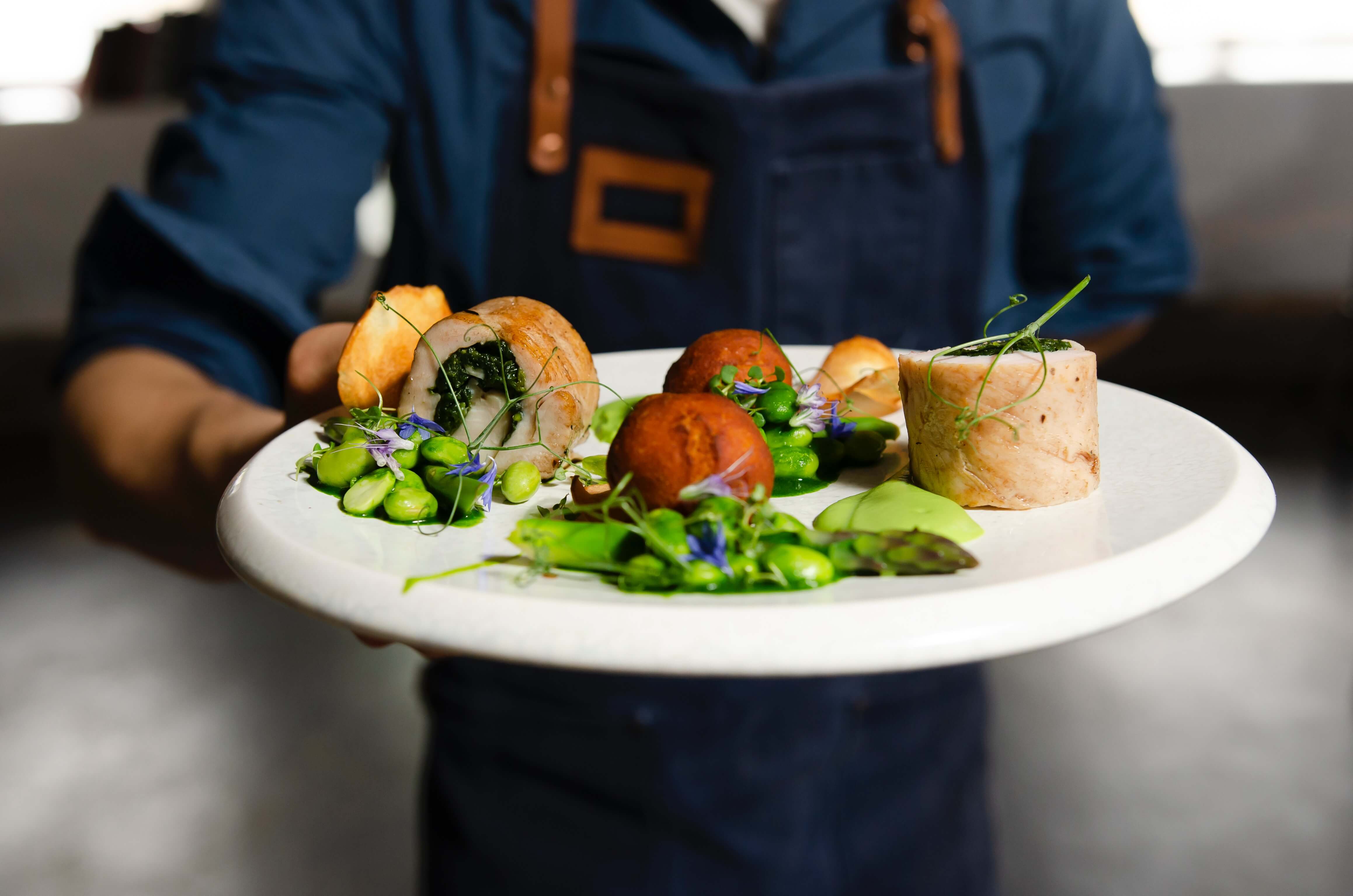 A server serves a plate of food.